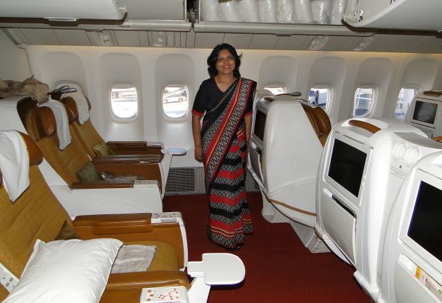 Boeing 777-200 (AT-ALA) - Very gracious stewardess on board our flight to Dehli, India.   Unfortunately, we did not get to sit in this first class section of the plane, but even economy class had a decent entertainment system to keep us watching Indian movies for nearly 14 hours!