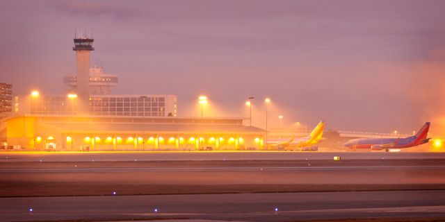 — — - Foggy Morning at Tampa International looking across the tarmac to the Southwest Airlines  Terminals