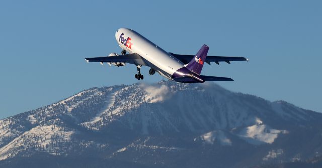 Airbus A300F4-600 (N733FD) - There are no skiers on the ski runs yet as FDX's "Lily" (N733FD), an A306, climbs away from RNO's Runway 16R and begins a cross country flight to Memphis (KMEM).