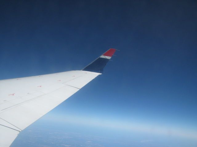 — — - Somewhere above the clouds between Florida and North Carolina.  Rain, heavy gray clouds leaving out of Sarasota, beautiful blue sky above the clouds.