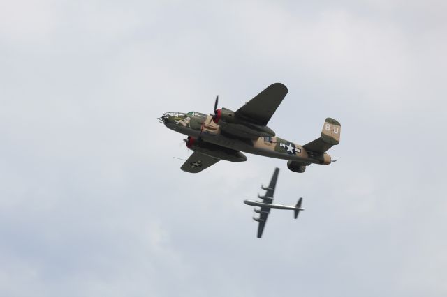 North American TB-25 Mitchell (N25YR) - The B-25 "Yellow Rose" does a mock bombing run While B-29 "Doc" circles in the background.