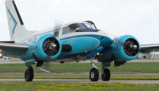 Beechcraft 18 (N14PW) - A colorful Beech 18 taxing to one of the grass tie downs at Oshkosh AirVenture 2015!