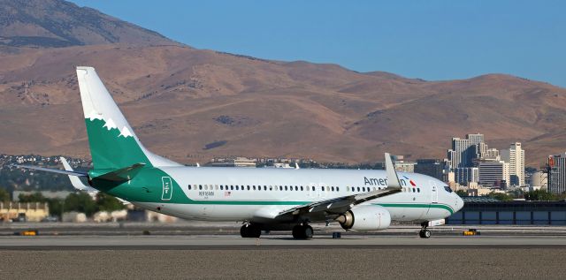 Boeing 737-800 (N916NN) - Americans "Reno Air" heritage livery (N916NN) begins accelerating down Reno Tahoe Internationals runway 34R for a morning departure to ORD.  A portion of the downtown Reno skyline, including Reno City Hall, can be seen in the background of the shot.