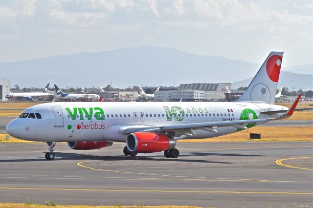 Airbus A320 (XA-VAT) - A320-323, airframe 7043, with the airline 10 anniversary sticker´s. Near to take off from 23R runway of Mexico City Airport. 