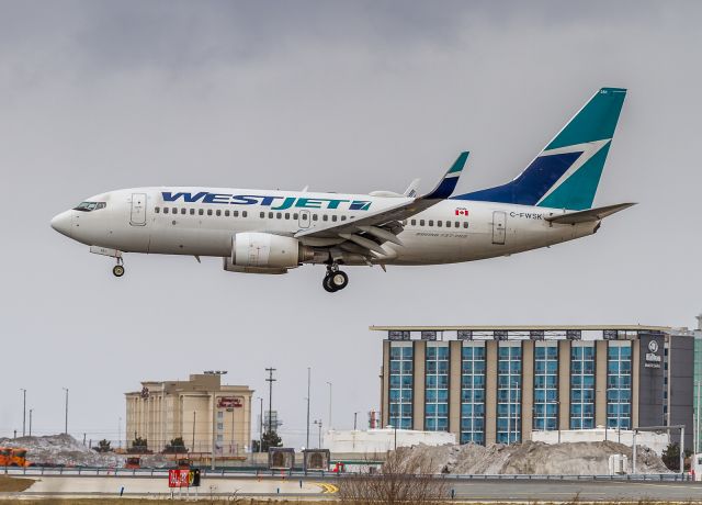 Boeing 737-700 (C-FWSK) - This Westjet 737 arrives from Winnipeg