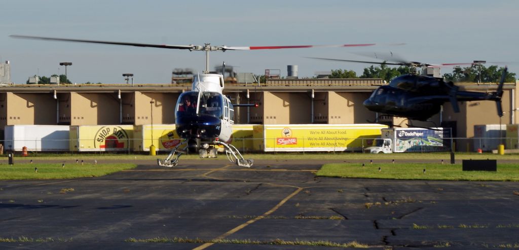 Bell JetRanger (N9BQ) - LINDEN, NEW JERSEY, USA-SEPTEMBER 04, 2018: Refueling at Linden Airport, N9BQ prepares to land and refuel while N429TD leaves the area after taking on fuel.