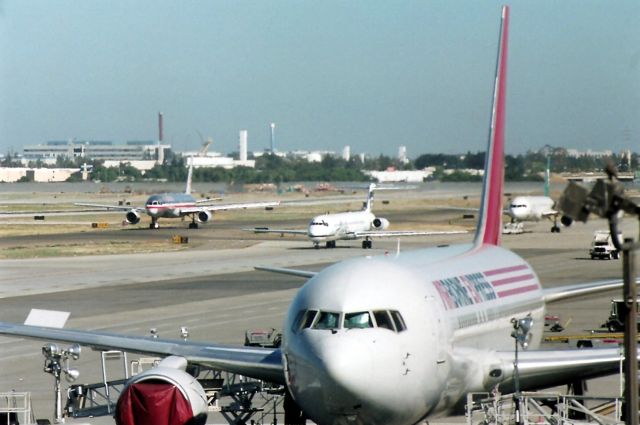 McDonnell Douglas MD-80 (N934AS) - KSJC- early action at San Jose, Alaska N934AS taxis on the mid taxiway as American 757 and a Mexicana 757 (tugged) all make their way to their destinations. View looking north.