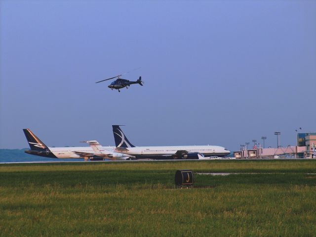 — — - Helicopter lifting off over KRFD Terminal