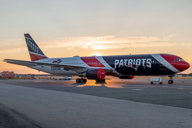 BOEING 767-300 (N36NE) - The Patriots' 767 resting at PVD with the sun rising behind it