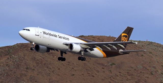 Airbus A300F4-600 (N139UP) - As a lady and a man gaze down at it from the top of Rattlesanake Mountain (which is an excellent location to view aircraft when the 34s are in use), a UPS heavy freighter (N139UP) passes between them and me as it is in the last few seconds of its s/final to 34L to complete a short flight from Ontario (KONT), CA.