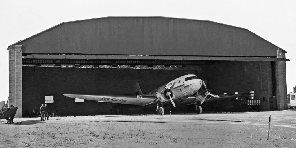 Douglas DC-3 (N33370) - * Not my photo * * Not my photo * (I was only 1 y/o when this was taken.)br /Flashback (Seventy-one years ago back to 1951) ~~br /A Mohawk Airlines DC-3, N33370, "Air Chief Cayuga," at an unknown airport in this very old photo taken in 1951.br /This is another photo from the memorabilia collection of Mr. Larry Myers. To learn why I am posting this photo from Mr. Myers's collection, go to the previous picture in my folder. The full explanation is provided under that picture.br /This particular DC-3 has an interesting history ....br /1943 .... Came off the Douglas production line intended to be delivered to an airline; however, the US government took ownership and it went into the USAAF as 43-2026.br /1944-45 .... To Pan American as NC33370.br /1948 ..... To Robinson Airlines (which became Mohawk Airlines) as N33370 (seen above) and was named "Air Chief Cayuga.'br /1958 ..... Reconfigured as a C-53 and reregistered as N410D. Remained in service with Mohawk.br /Mohawk was bought by Allegheny in early 1970s. Prior to that, N410D (N33370) was WFU by Mohawk and was purchased by a private charter airline; Hansen Air.br /8 Mar 64 ..... While on approach to Chicago transporting 28 members of a ski team, was inbound behind a TWA jet. Encountered vortex turbulence and crashed into a home. One pilot was fatally injured; the other pilot and all members of the ski team survived. N410D was w/o. The probable cause was determined to be the vortex turbulence but a contributing factor was the failure of the pilots to utilize anti-icing features which led to problems controlling the descending plane, esp when it encountered the vortex turbulence behind the TWA jet.