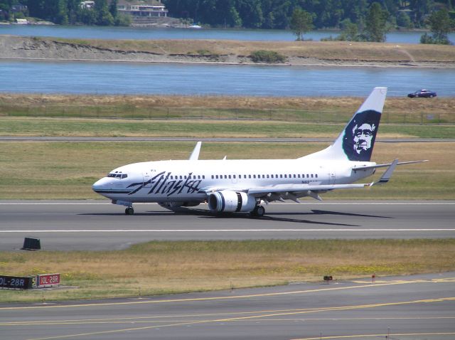 Boeing 737-700 (N626AS) - July 6, 2011, around midday; decelerating after landing, 28R. Taken on top level of parking garage.