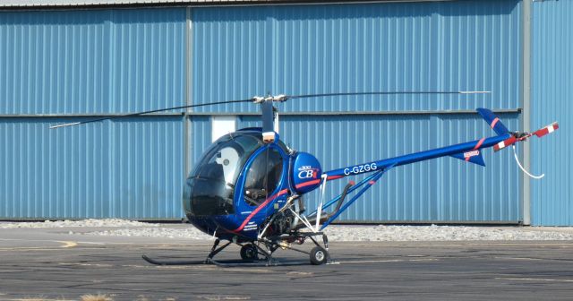 SCHWEIZER 269 (C-GZGG) - Catching some tarmac time is this 2005 Schweizer 300 CBi (269C-1) Helicraft in the Summer of 2023.