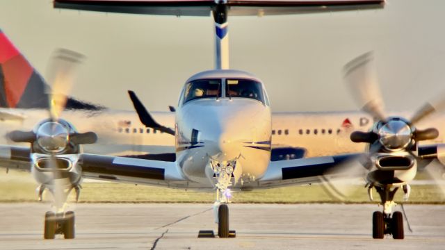 Beechcraft Super King Air 350 (N701FC) - Fargo Jet Center’s B350 getting ready to head back home after the ISU v. NDSU game.br /br /(ft. NDSU’s charter on takeoff roll in the background)br /br /This aircraft is a 2000 Beechcraft 300 Super King Air 350, SN FL-291, owned/operated by Fargo Jet Center. 10/8/22. 