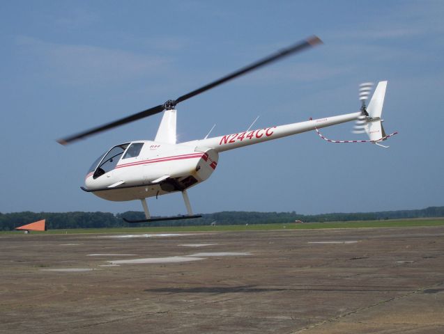 Robinson R-44 (N244CC) - Departing THA at a high angle of attack enroute to the Bonnaroo Music Festival in Manchester TN.  Helicopter was working as a photo platform and VIP transport for the festival.