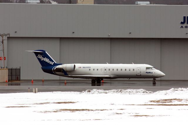 Canadair Regional Jet CRJ-200 (N699BR) - Sky West CRJ200 at Hanscom presumably doing a sports charter on 2/27/21. 