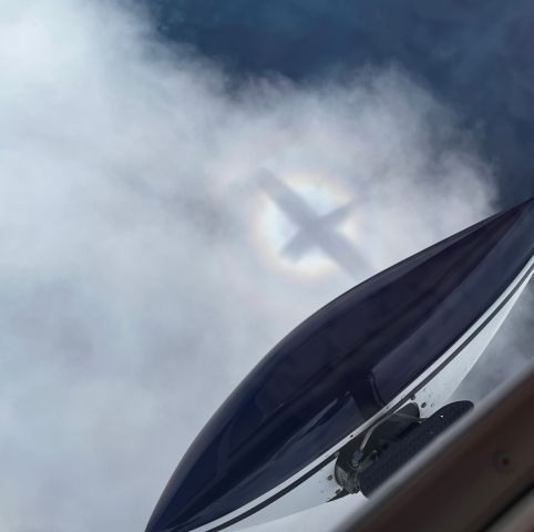 Cessna Skyhawk (N172EG) - IFR above the clouds over Lake Michigan. Photographed our silhouette on the clouds with the right wheel pant showing. Enroute to Ohio from KGRB. 1965 Cessna 172F.