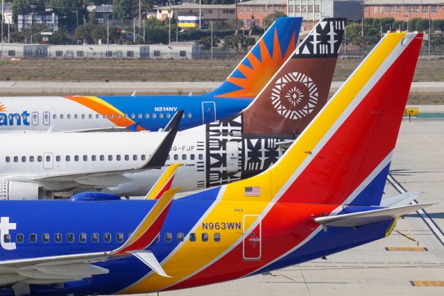 Boeing 737-700 (N963WN) - An interesting line-up of tails at the remote stands