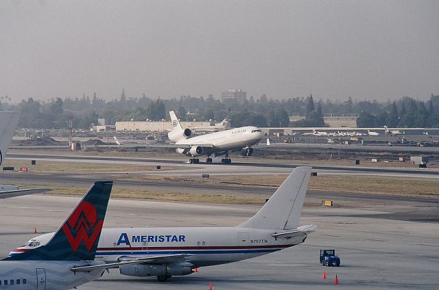 Boeing MD-11 (N271WA) - KSJC - 30R touchdown for World Airways MD-11 at San Jose, note Runway 30L tore up for Runway extension and overall improvements, 