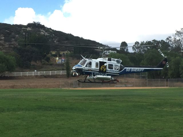 Bell UH-1V Iroquois (N107BZ) - San Diego County Copter 12 Hovering after picking up its Cal-Fire Crew. Joint operation with SD Sheriffs and CALFIRE.