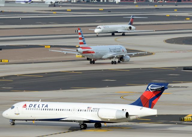 Boeing 717-200 (N859AT) - N895AT is taxing on S to the active while a American A320 (N649AW) is taxing on D to the active and a Delta MD-90 (N939DN) is taking off from 7L. 