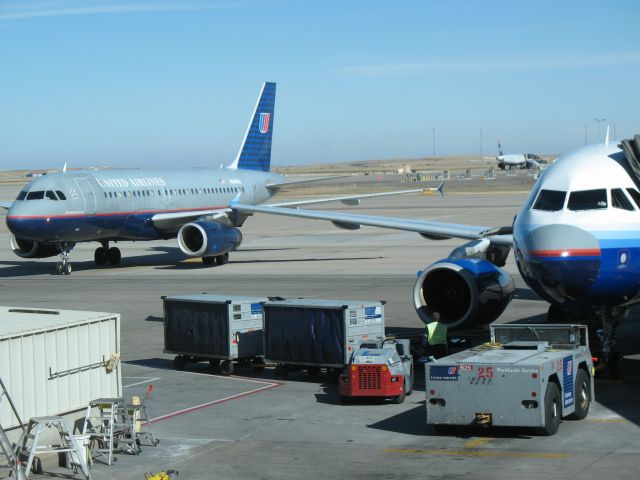 N848UA — - A couple of Airbuses parked at C terminal in Denver. The A320 on the right needs a nose job.