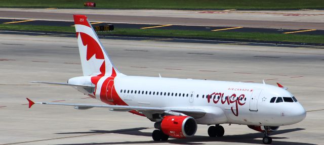 Airbus A319 (C-FYNS) - Air Canada Rouge Airbus A319 taxiing into gate E73 after a two hour flight from Toronto as ROU1890.