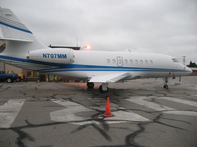 N707MM — - Falcon N707MM Parked on the main flight ramp area at FBO York Aviation on a damp rainy morning .