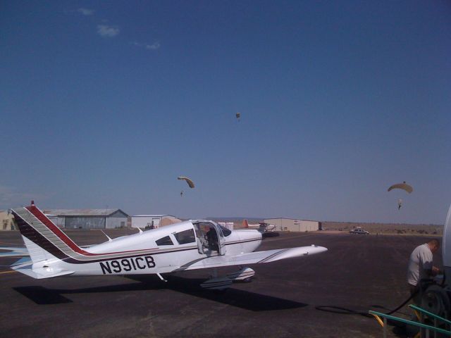 Piper Cherokee (N991CB) - 1V6 - Canon City.  Topping off tanks while AFA doing training in background.  Actually didnt see them while taking pictures.