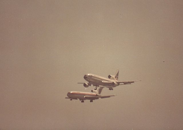 BOEING 727-200 — - KSFO - B727 and a Delta L-1011 on dual approach to runways 28 L/R in this late 1970s early 80s photo from Bayfront park- 35mm Minolta X7 1000mm Celestron Lens, long before the days of Digital lens and Ben Wang photos. Love that Flightaware watermark on the photo...................not!