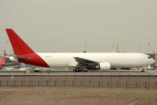 BOEING 767-300 (N371CM) - Cargo Aircraft Management Boeing 767-338 N371CM at Phoenix Sky Harbor as Airborne Express flight ABX2010 from Los Angeles on November 26, 2015. It first flew on August 10, 1994. Its construction number is 25577. It was delivered to QANTAS as VH-OGO on August 26, 1994. Cargo Aircraft Management registered it as N371CM in June 2015 and converted it to freighter configuration. Its QANTAS heritage is revealed by the faint kangaroo tail.