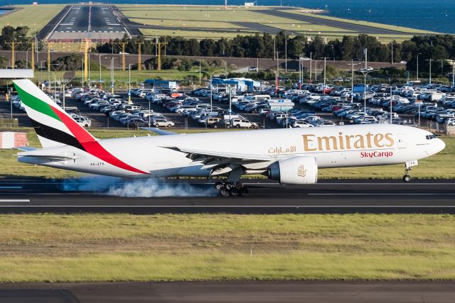 BOEING 777-200LR (A6-EFK) - Emirates Sky Cargo touching down RWY25, Sydney.