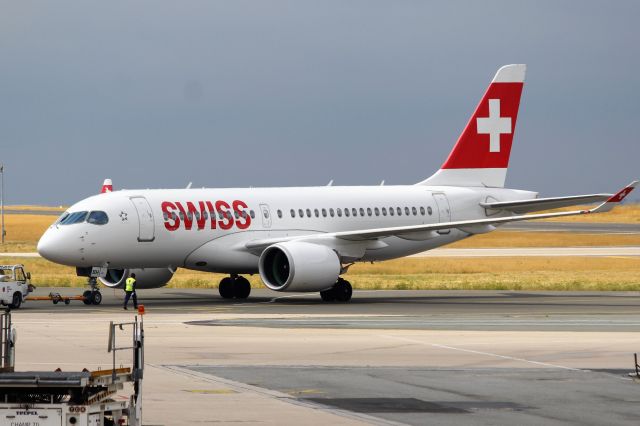 Airbus A220-100 (HB-JBH) - Swiss International Airlines (LX) HB-JBH A220-100 [cn50017]br /Paris Charles de Gaulle (CDG). Swiss flight LX639 to Zurich (ZRH) pushes back from the gate. This aircraft was delivered in early 2017 as a Bombardier CS100, prior to Airbus’ majority stake holding of the model in October 2017 which subsequently re-designated the type as Airbus A220.br / br /Taken from Terminal 1 arrivals level.br /2018 08 09br /Swiss International Airlines;LX;HB-JBH; A220-100;50017;ZRH;CDG;LX639; Bombardier;CS100