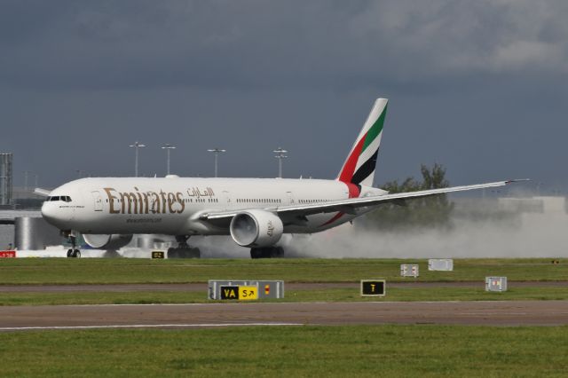 BOEING 777-300ER (A6-ENK) - EK18 departs to Dubai.  A rainy damp day produces fog in the engine inlets.