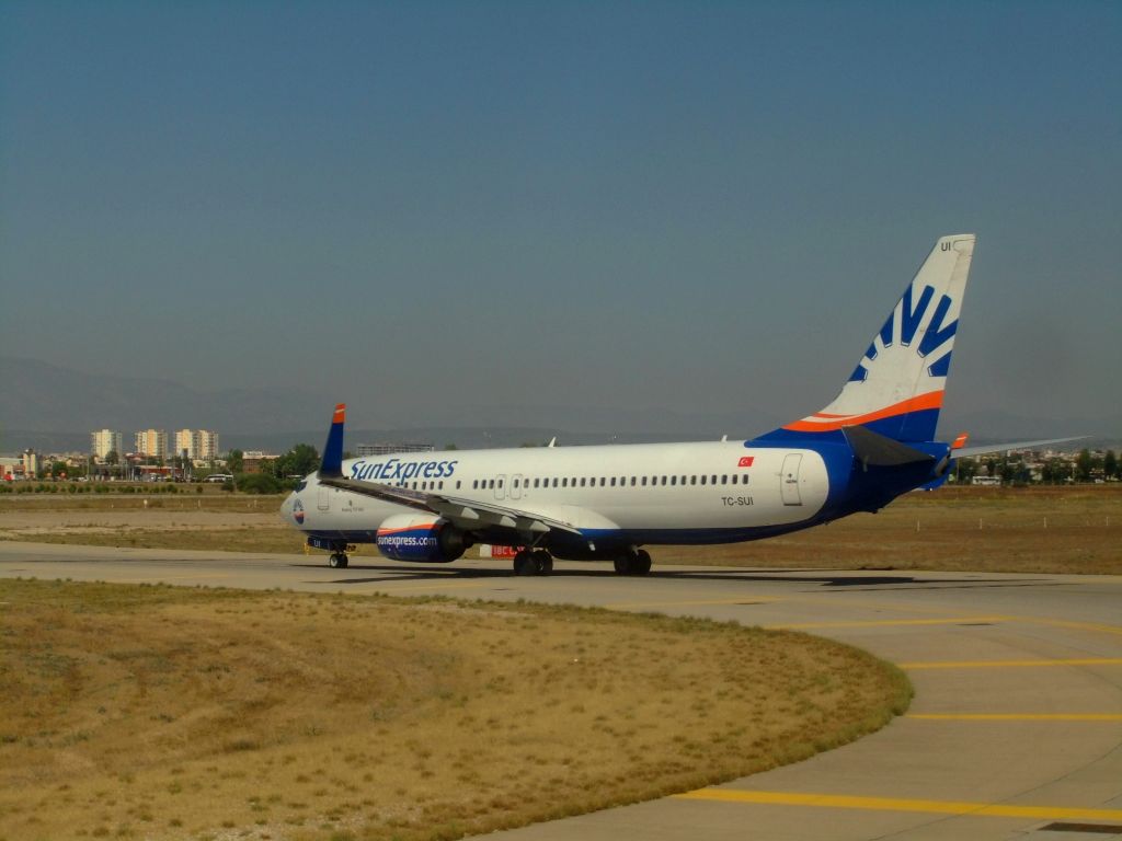 Boeing 737-800 (TC-SUI) - SunExpress B737-800(WL) TC-SUI, delayed flight XQ9091 AYT-ADB, seen from Turkish Airlines B737-800(WL) TC-JHE, my flight TK2411 AYT-IST. Taxiing to 18R. In a few minutes, takeoff to IST. Photo made 27.09.2013.