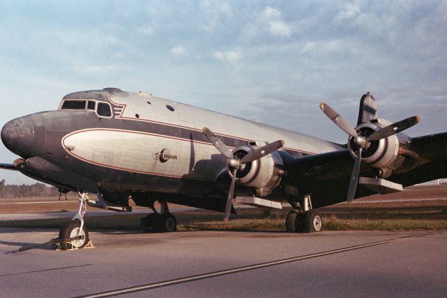 Douglas C-54 Skymaster (NOTKNOWN) - Long abandoned DC-4 at Douglas Airport in Georgia. Was sold at auction in 2017 or so. I believe it's still sitting there. Photo shot in 35mm around 2016.