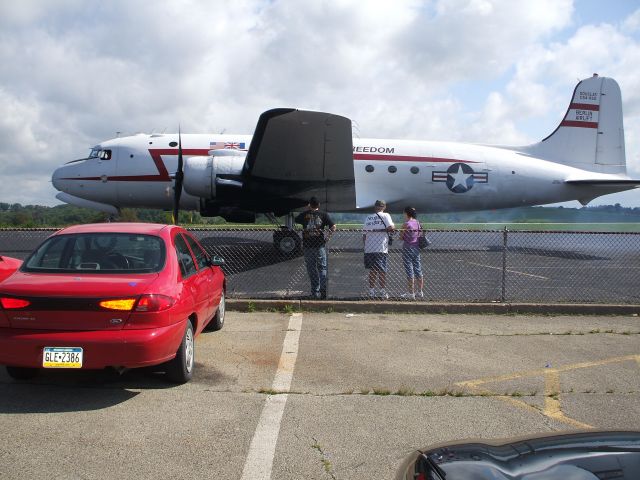 Douglas C-54 Skymaster (N500EJ) - Douglas C-54 (Spirit of Freedom) in the process of starting its four engines on main ramp at Washington County.