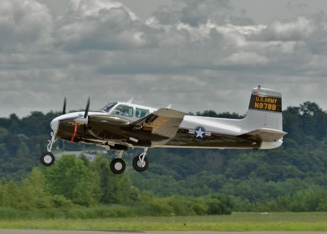 Beechcraft Twin Bonanza (N978B) - Departing KSCH, just prior to it's departure to it's  new home in Germany