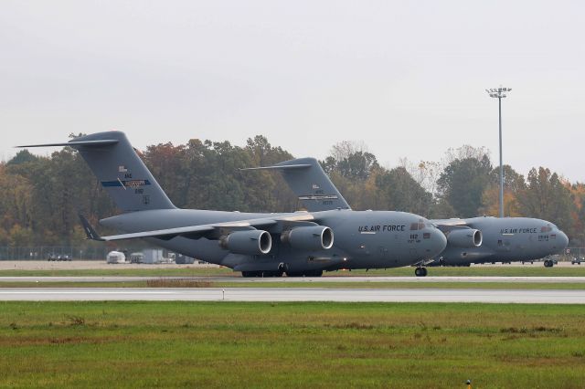 Boeing Globemaster III (02-1112) - A pair of Boeing C-17 Globemaster III’s seen at KTOL on 22 Oct 2020. 02-1112 was taxiing out for departure as 90-0535 was being loaded on the cargo ramp.