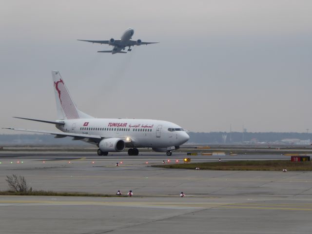 BOEING 737-600 (TS-IOP) - Tunisair B737-600 TS-IOP going to rwy 18 west, whilst a United B777 is starting from rwy 25C. FRA, 16.01.2016.