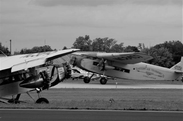 NC9645 — - Trimotors at Oshkosh in Vintage B&W.   One takes-off while the other lands.