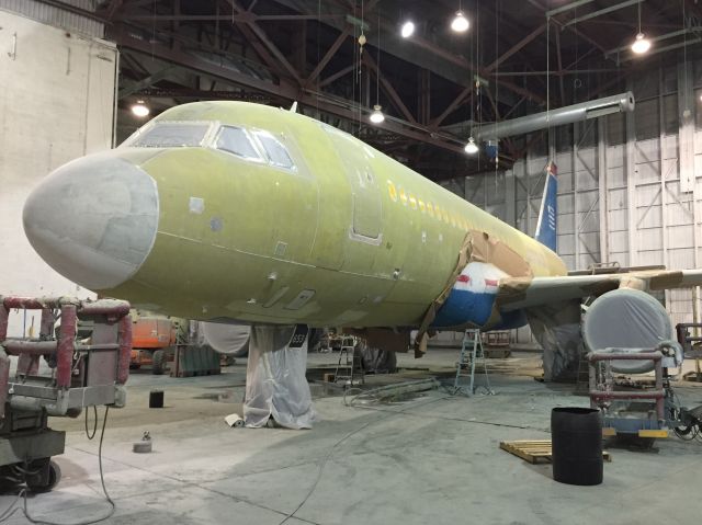 Airbus A320 (N653AW) - N653AW, former America West/US Airways, being stripped in preparation for its new American paint scheme. 