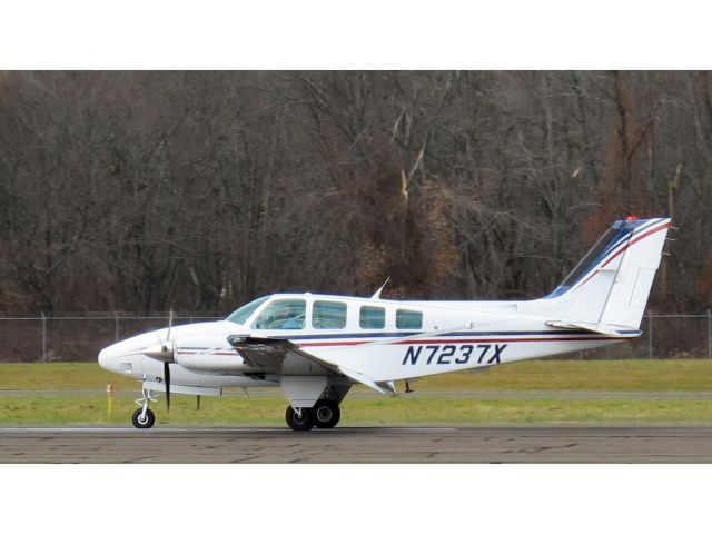 Beechcraft Baron (58) (N7237X) - Landing rollout runway 26.