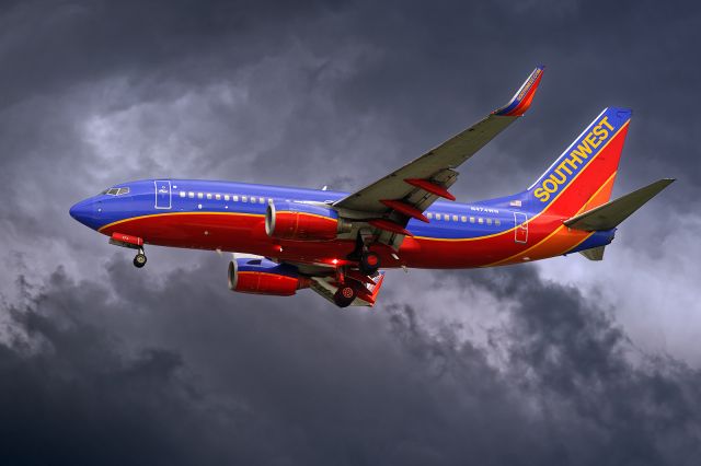 Boeing 737-700 (N474WN) - 7/3/2015. Right on the edge. Big storm NE of KTPA. Field reconfigured to N landings, This is a short approach to 1L.