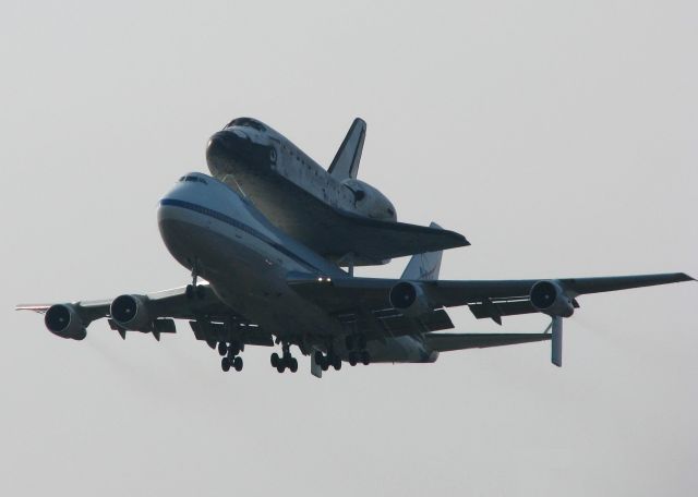 Boeing Shuttle Carrier (N911NA) - Space Shuttle Discovery landing on runway 15 at Barksdale Air Force Base, Louisiana. Spending the night before heading back to Florida. Had to shoot this looking into the sun!