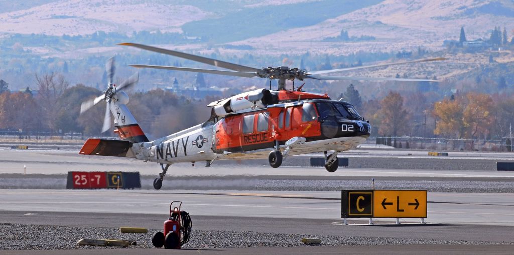 Sikorsky S-70 (16-5760) - A Sikorsky MH-60S Seahawk (165760) of the Navy's "Longhorns" SAR (Search and Rescue) Team (NAS Fallon) is a heartbeat or two away from touching tires to the concrete at the intersection of taxiways Lima and Charlie in this snap taken about 45 minutes before noon.  