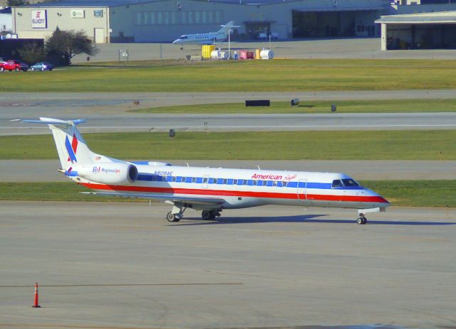 Embraer ERJ-135 (N808AE) - A American Eagle Airlines ERJ-135 taxiing to the gate after landing on runway 13 from Chicago. It had a very fast turn-around; 25 minutes. This was taken from the top floor of the north parking garage at the Des Moines Intl. Airport on Friday, October 29, 2010