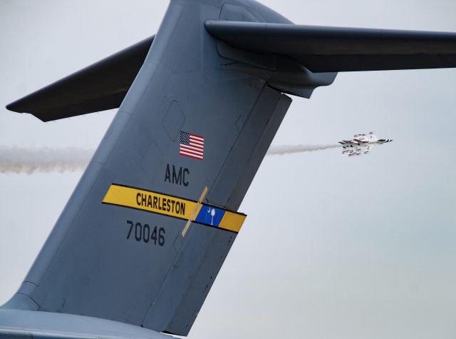 Boeing Globemaster III (N70046) - The USAF Thunderbirds passing behind the static C-17 from just down the road at Charleston AFB.  Taken at the 2022 Shaw Air and Space Expo.  4/2/2022.