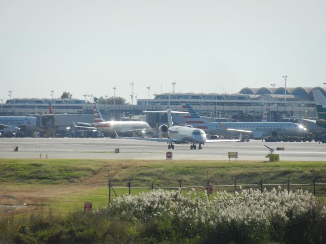 Embraer 175 (N410YX) - Republic Airlines Embraer E-175 N410YX Having Its Passenger's Luggage Boarded On. N526EA, An American Express Bombardier CRJ-700 Taxiing To The Runway. An American Express Embraer E-175 Is Seen At The Gate Behind N526EA. On The Right Side Is N516NN, An American Airlines Boeing 737-800 Painted In Reno Air Retro Livery, American Airlines Will Keep This Aircraft Painted In Those Colors As A Heritage Livery