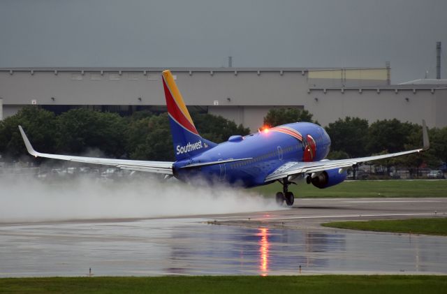 Boeing 737-700 (N409WN) - "Triple Crown One" departs a very stormy Dallas Love Field.